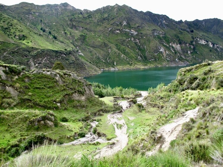 Views of Quilotoa Lake in Ecuador from near the bottom of the crater surrounded by lush green vegetation