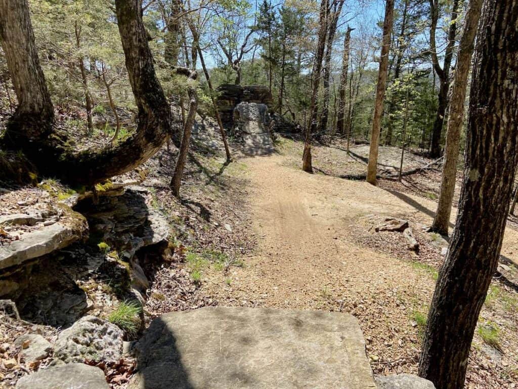 Huge rock step-up jump on trail at Lake Leather mountain bike park in Arkansas