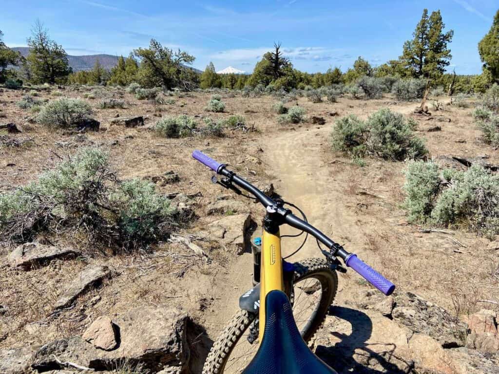 Photo out over front of mountain bike onto singletrack trail in Maston Trail System in Bend Oregon
