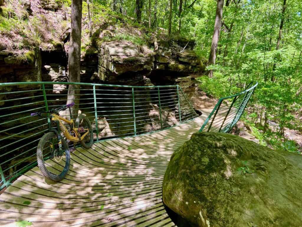 Curvy bridge on singletrack trail at Mt. Nebo in Arkansas with bike leaning against metal railing