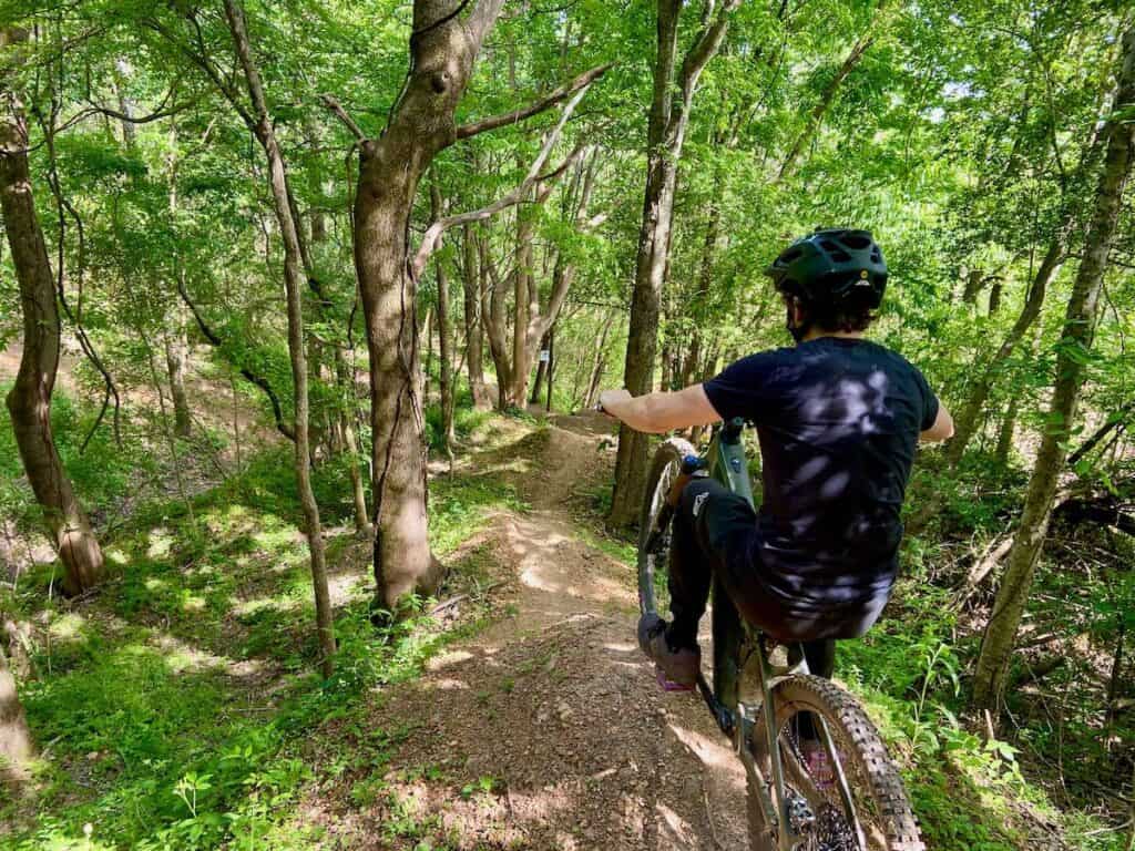 Mountain biker stopped at top of downhill trail at Ride BHM Bike Park in Alabama