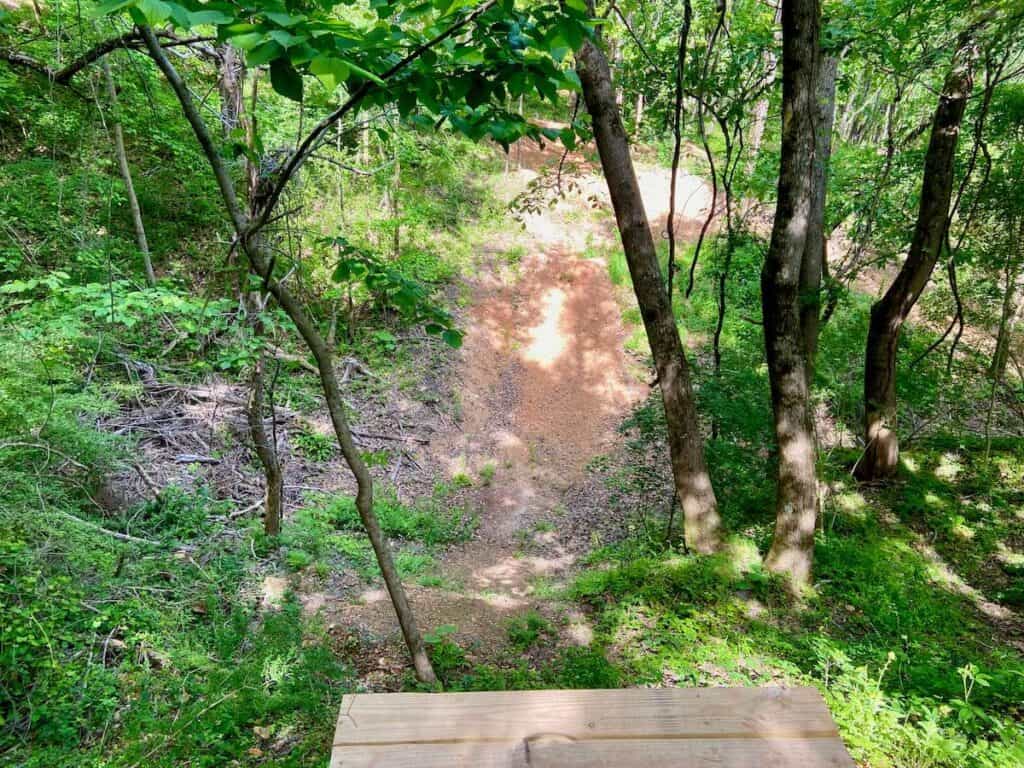 Large wooden drop on mountain bike trail at Ride BHM Bike Park in Alabama