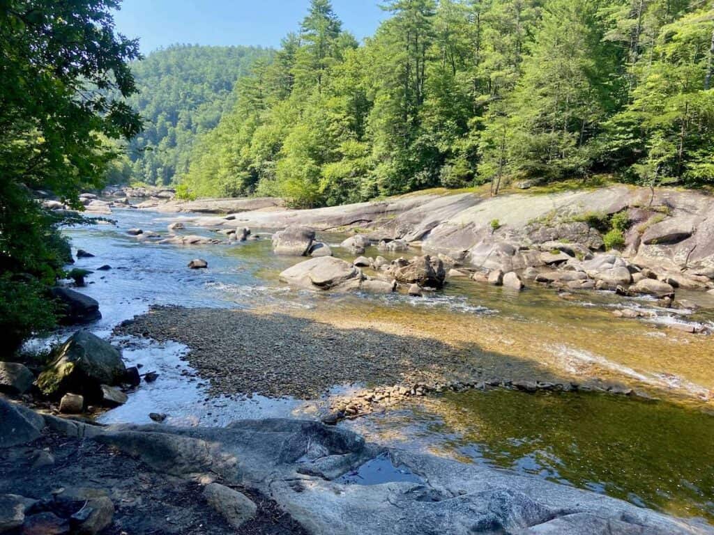 Scenic shallow river with large boulders and pebbly beaches in North Carolina