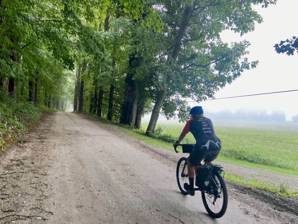 Man riding gravel bike on dirt road in Vermont