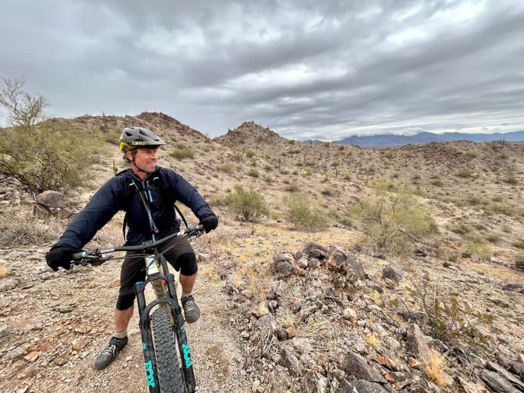 Mountain biker on bike looking out over desert view from Fantasy Island North trail network in Phoenix