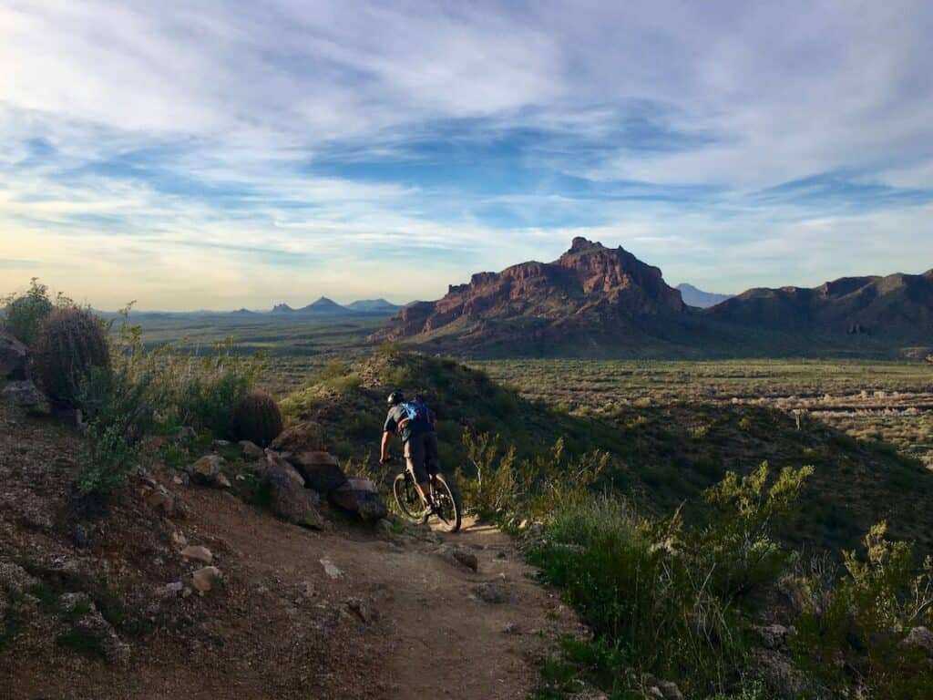 mountain biker riding down technical singletrack trail at Hawes trail network in Phoenix