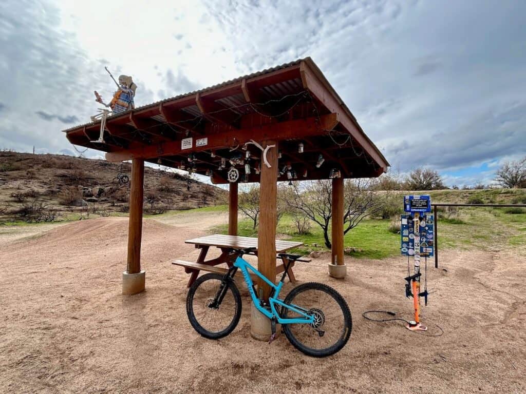 Mountain bike leaning against wooden shelter at Jackass Junction on the Pemberton Trail Loop at McDowell Mountain Regional Park