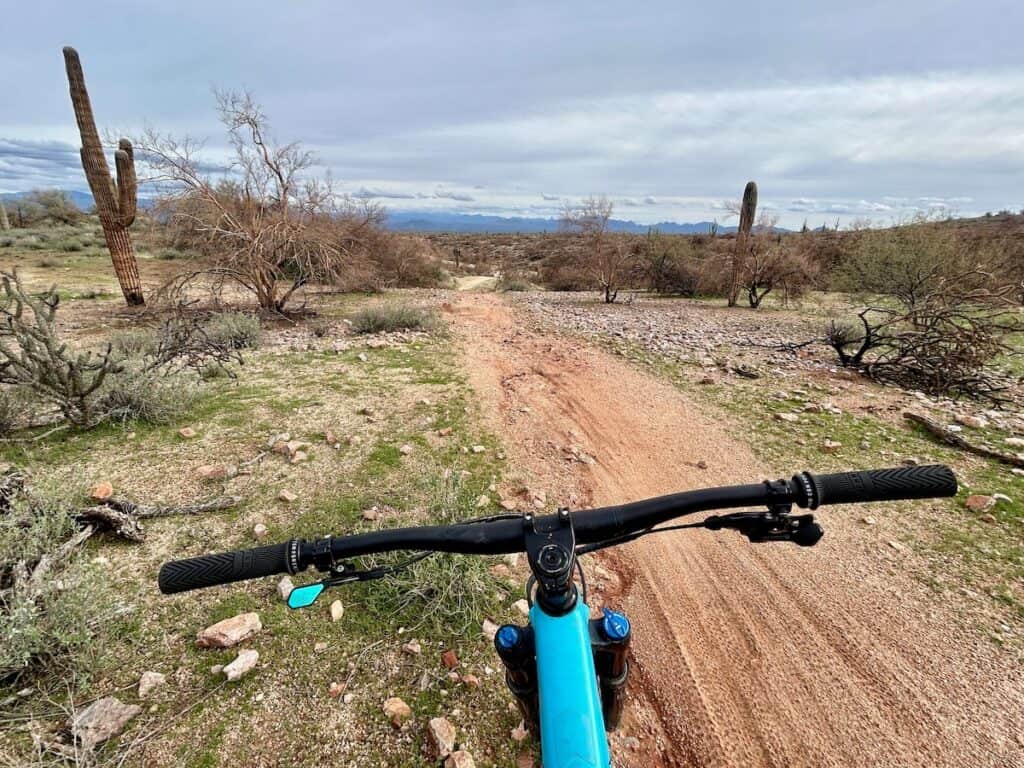 Views out over handlebars of mountain bike on to Pemberton Trail at McDowell Mountain Regional Park in Phoenix