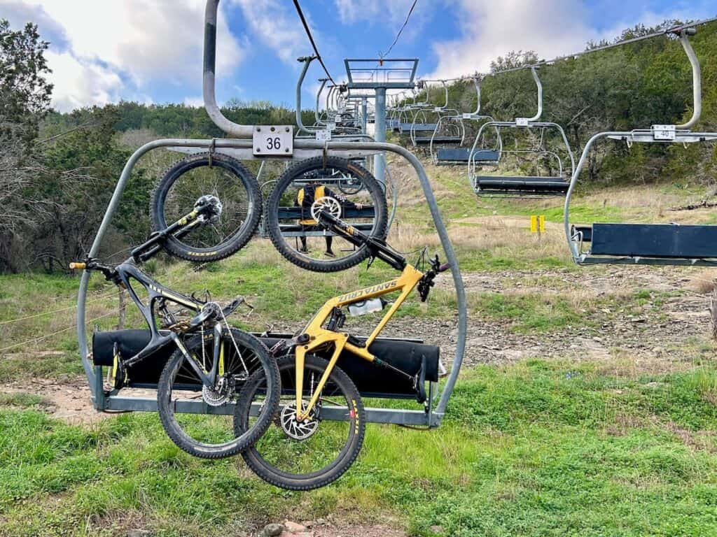 Bikes loaded on the the back of a chairlift at Spider Mountain Bike Park in Texas