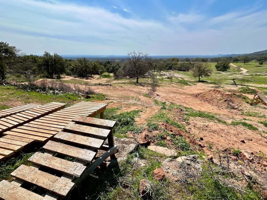 Series of wooden ramp drops at Station Mountain Bike Park in Texas