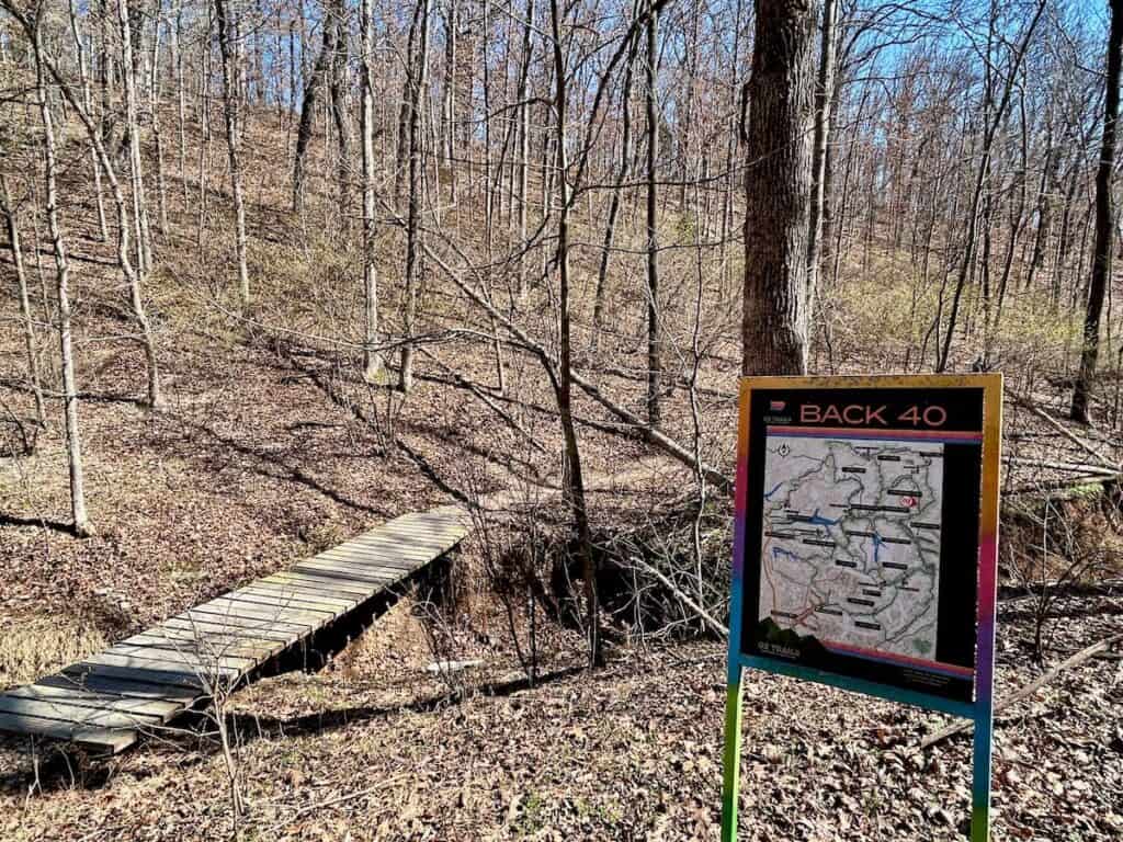 Trail sign on wooded trail