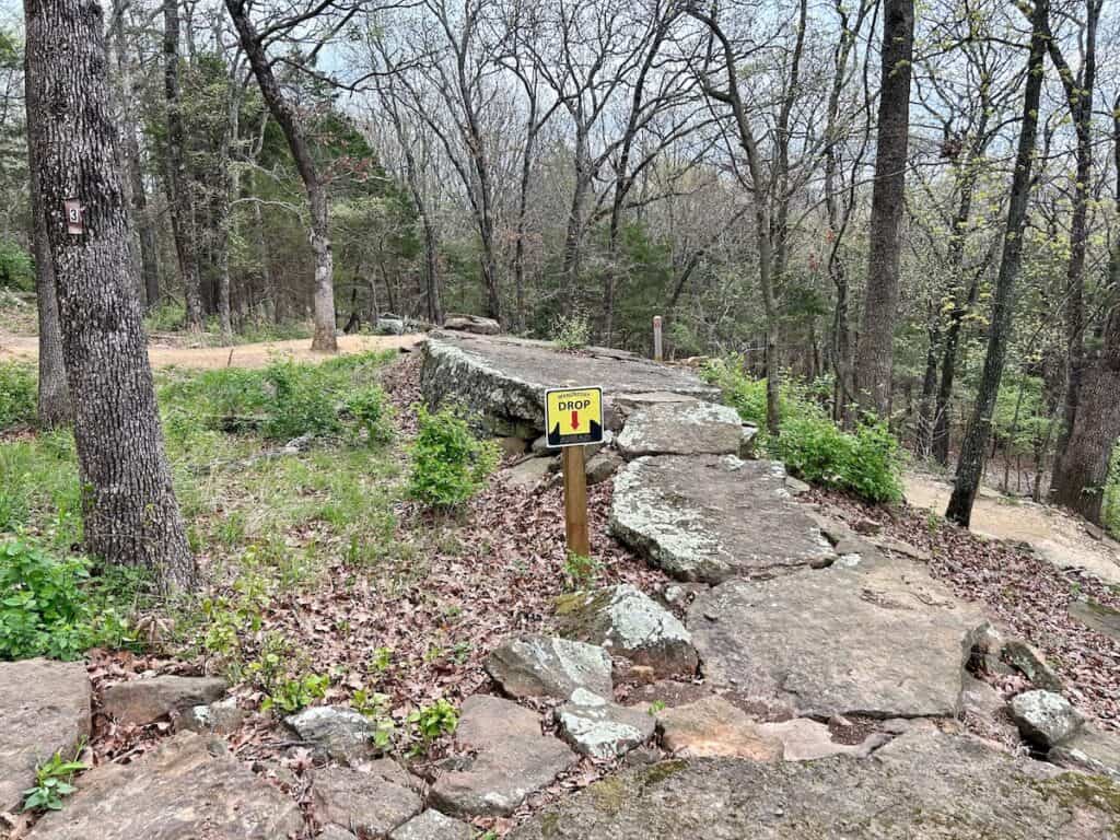 Rock bridge and drop on mountain bike trail at Centennial Park in Fayetteville, Arkansas