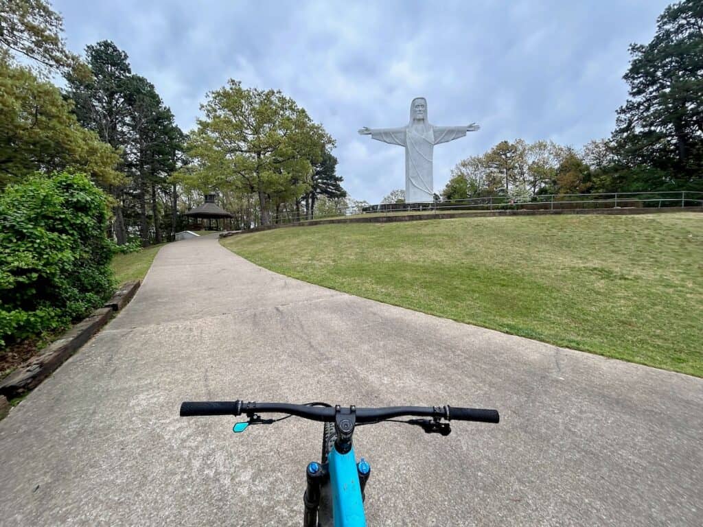 Photo out over from of mountain bike handlebars of the Christ of the Ozarks statue