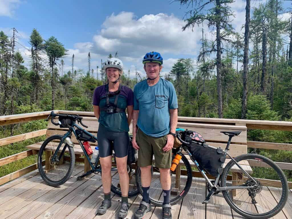 Two bikepackers standing in front of bikes