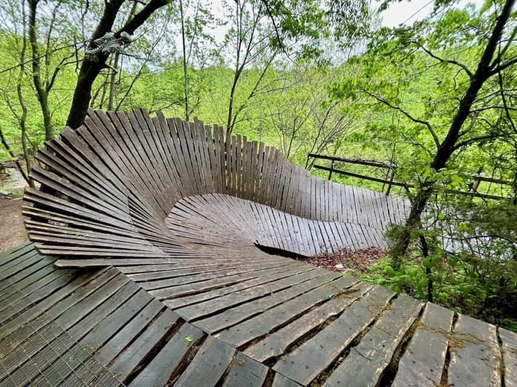Curved wooden ramp on mountain bike trail